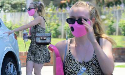 Dakota Fanning sports a bright pink face mask and a leopard dress as she runs errands in Los Angeles - dailymail.co.uk - Los Angeles - state California - city Los Angeles