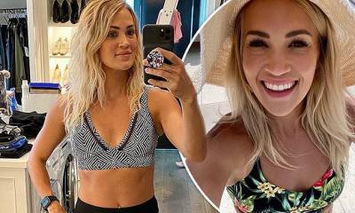 Carrie Underwood showcases her phenomenal figure and gym-honed abs in chic black and white bikini - dailymail.co.uk