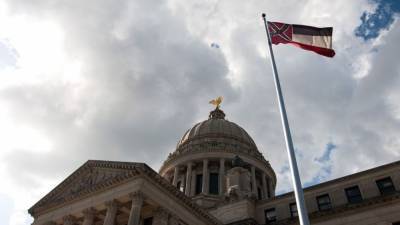 Tate Reeves - With a pen stroke, Mississippi drops Confederate-themed flag - fox29.com - state Mississippi - Jackson, state Mississippi