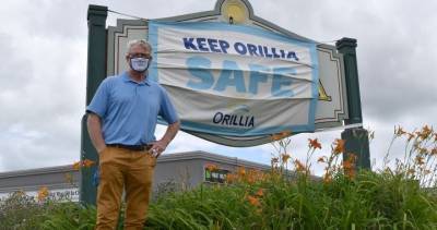 Steve Clarke - Orillia, Ont., installs large masks on entrance signs to drill home COVID-19 safety message - globalnews.ca - county Simcoe