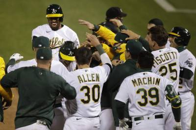 Marcus Semien - Matt Olson - In 1st MLB game with new extra-inning rule, A's slam Angels - clickorlando.com - Japan - Los Angeles