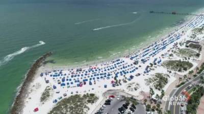 Coronavirus: Floridians hit the beach amid record COVID-19 spike - globalnews.ca - state Florida