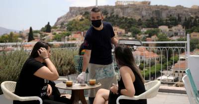 Greece enforces strict night-time curfew on holiday islands after coronavirus spike - mirror.co.uk - Greece - city Santorini