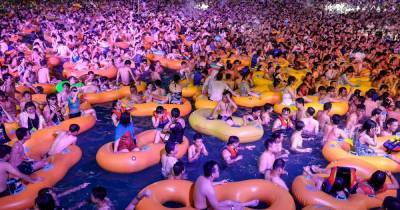 Wuhan pool party with hundreds crammed close sparks Covid-19 second wave fears - dailystar.co.uk - city Wuhan - province Hubei