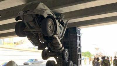 Dump truck becomes suspended in air after hitting an overpass, officials say - clickorlando.com - state Florida - county Seminole
