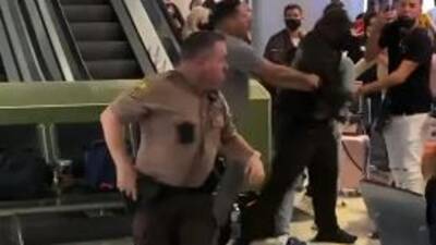 Massive brawl breaks out at Miami airport, suspects nabbed after biting cop's head - fox29.com