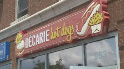 Décarie Hot Dogs owners full of gratitude as greasy spoon bestowed top honour - globalnews.ca