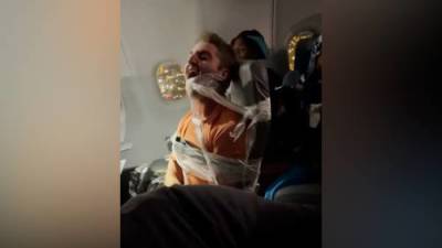 Unruly passenger duct-taped to seat after allegedly assaulting flight attendants - globalnews.ca - county Miami