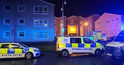 Man found dead in block of Scots flats and woman in hospital after 'disturbance' - dailyrecord.co.uk - Scotland