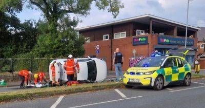 Emergency services descend on major road as car left on side following crash - manchestereveningnews.co.uk - city Manchester